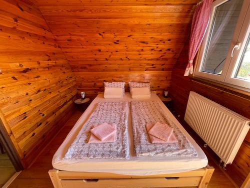 an overhead view of a bed in a wooden room at Chatička Lukov in Lukov