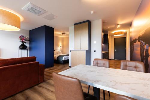 a living room with a dining room table and a bedroom at Longstay Achterhoek in Zeddam