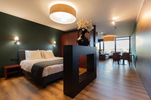 a bedroom with a bed and a vase with flowers at Longstay Achterhoek in Zeddam