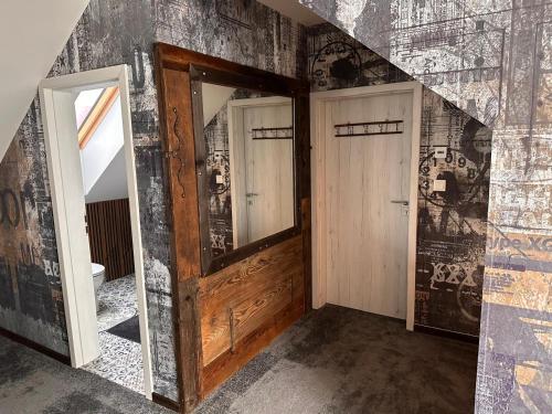 a hallway with a door and a wall with graffiti at Ateliér Kráľovič in Hokovce