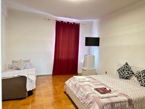 a bedroom with two beds and a red curtain at Good Morning Venice in Venice