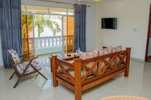 a living room with a couch and a table at Nightingale Apartments Hotel Mombasa in Shanzu