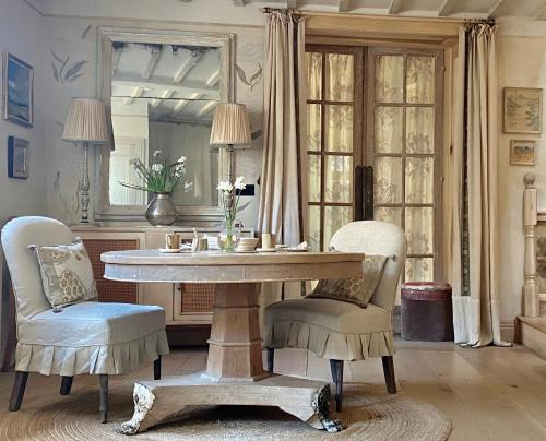 a dining room with a table and two chairs at Angel Yard in Woodstock