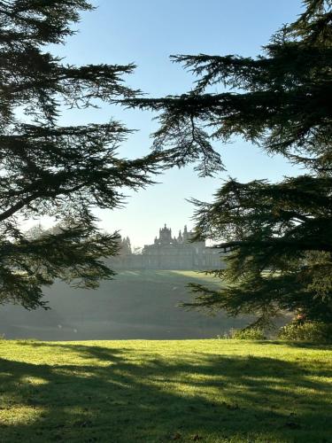 a view of a castle from between two trees at Angel Yard in Woodstock