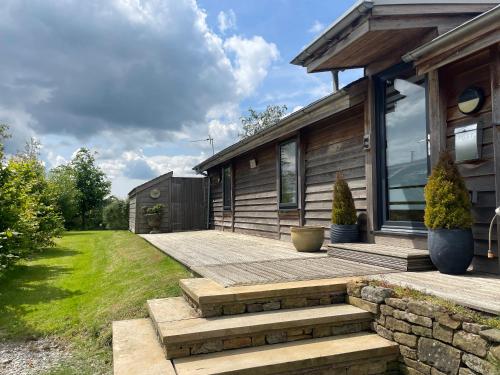 a home with a patio and a house at Artisan Lodge in Preston