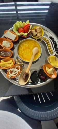 a tray filled with different types of food on a table at AĞARAN WOODEN HOUSEs in Rize