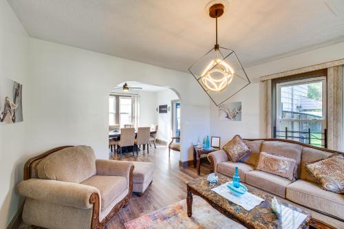 a living room with two couches and a table at 4 Mi to Dtwn Home with Patio in Cleveland! in Cleveland