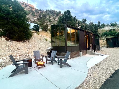 a tiny house with a table and chairs on a patio at Red Hollow in Orderville