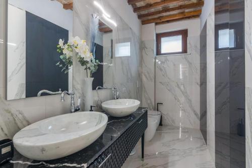 a bathroom with two sinks on a black counter at Villa Azzurra in Pesaro