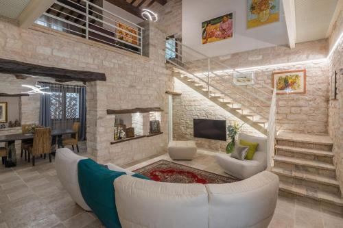 a living room with a couch and a tv at Villa Azzurra in Pesaro