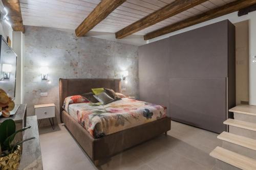 a bedroom with a bed and a stone wall at Villa Azzurra in Pesaro