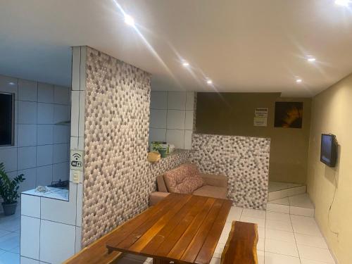 a living room with a couch and a table at Linda casa em Enseada dos Corais in Cabo de Santo Agostinho