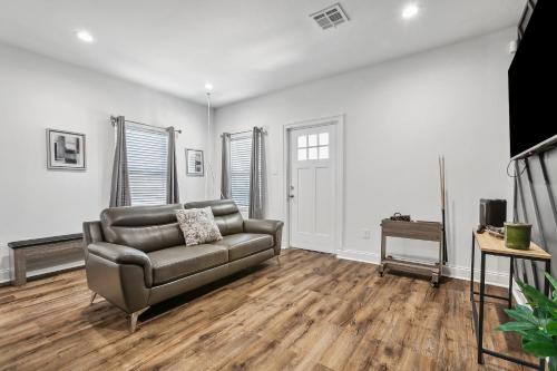 a living room with a couch and a television at Charming NOLA Oasis in New Orleans