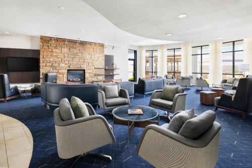 a lobby with couches and chairs and a fireplace at Courtyard by Marriott Amarillo West/Medical Center in Amarillo