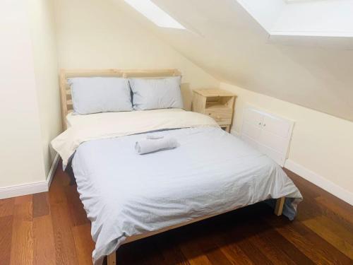 a small bedroom with a bed in the attic at Sunny room near Brown University, Whole Foods with shared bathroom 342 in Providence