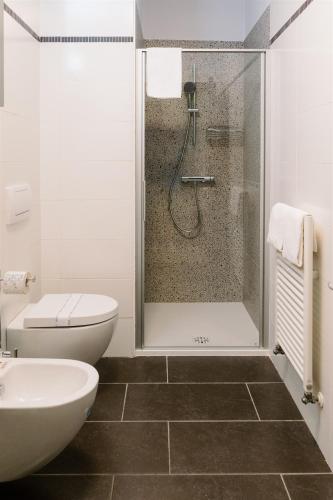 a bathroom with a shower and a toilet and a sink at Residence Carlton in Ferrara