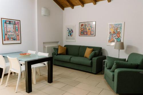 a living room with a couch and a table at Residence Carlton in Ferrara