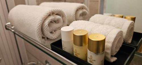 a bathroom mirror with towels and towels on a shelf at Hotel Elvezia - Self Check-in in Lavorgo