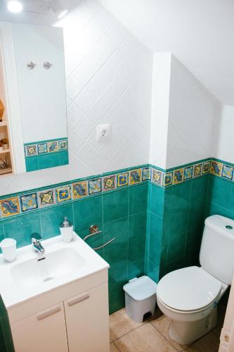 a bathroom with a toilet and a sink at Loft Molino de Erillas in Alora