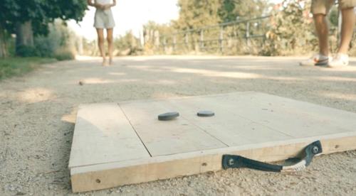 a wooden table with two stones on top of it at Domaine des Thomins in Cisai-Saint-Aubin