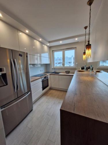 a large kitchen with a large island in the middle at Rayskiego Premium Apartment in Warszawa