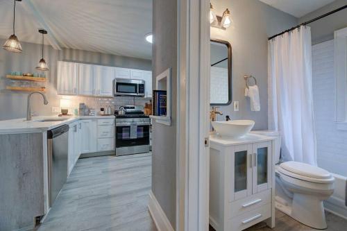 a white bathroom with a sink and a toilet at Stylish home Garage Walk to Lake Minutes from Airport in Saint Francis