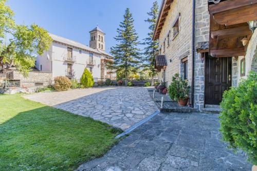 a stone driveway in front of a building at Casa El Pajar I y II in Senegüé