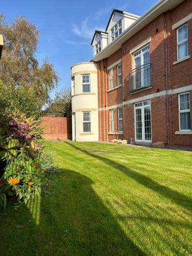 a large brick building with a grass yard at Stockmans Stay, Belfast in Belfast