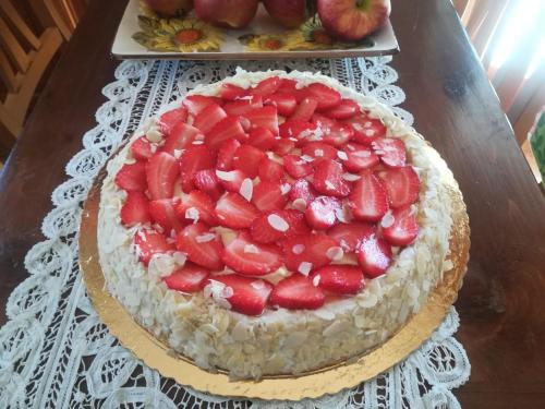 a cake with strawberries on top of a table at B & B L'ABBRACCIO in Agnone
