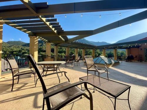 a group of chairs and tables on a patio at Manitou Incline Retreat in Manitou Springs