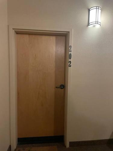a door in a hallway with a light above it at Manitou Incline Retreat in Manitou Springs