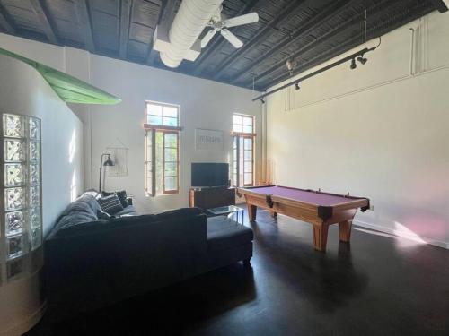 a living room with a couch and a pool table at Manitou Incline Retreat in Manitou Springs