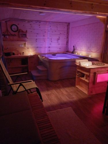 a large bathroom with a tub and a table at Edenski vrt in Ivančna Gorica