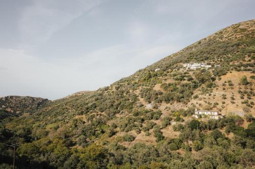 a house on the side of a mountain at Lefteris Rooms in Kámbos