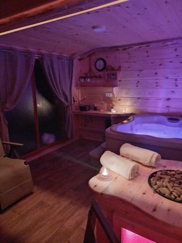 a room with a tub and a table in a room at Edenski vrt in Ivančna Gorica