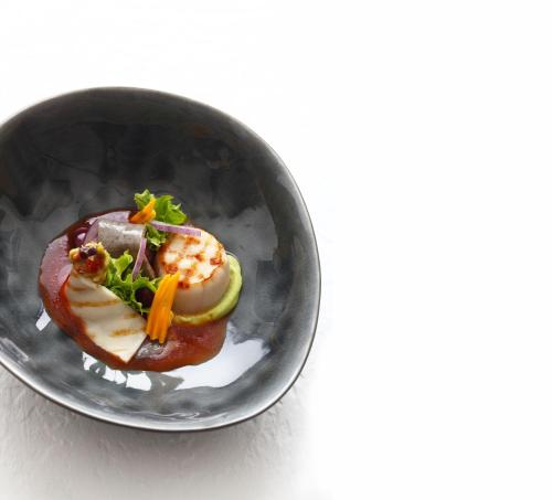 a small bowl of food with vegetables in it at LA MAISON hotel & spa in Saarlouis