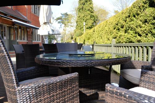 a wicker table and chairs on a patio at Hopping Hare in Northampton