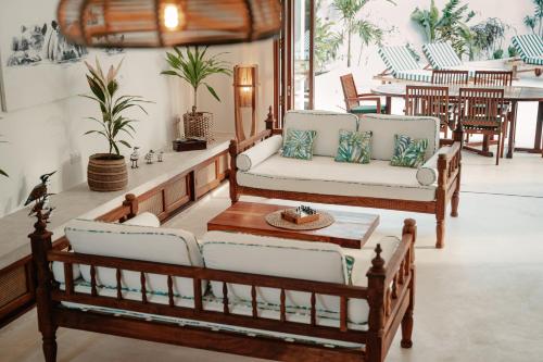 a living room with two couches and a table at Eden Escapes - Diani Beach, Kenya in Diani Beach