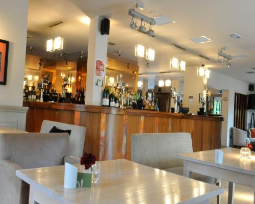 a restaurant with tables and chairs and a bar at Hopping Hare in Northampton