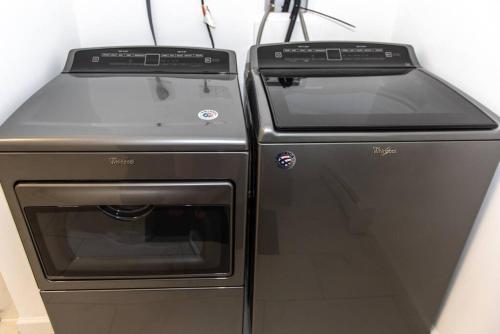 two ovens sitting next to each other in a kitchen at New Renovated vacation house in Brady Park