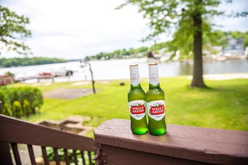two bottles of beer sitting on top of a fence at New Renovated vacation house in Brady Park