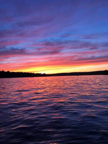 a sunset over a large body of water at New Renovated vacation house in Brady Park