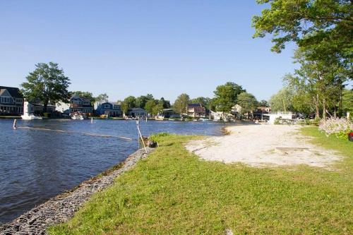 a river with houses and a sandy beach next to it at New Renovated vacation house in Brady Park