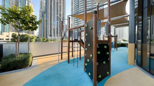 a playground on the roof of a building with tall buildings at Best View In Dubai With FULL Burj Khalifa, Fountains, Park View, Next to Dubai Mall and Opera in Dubai