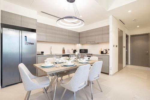 a dining room with a table and chairs in a kitchen at Best View In Dubai With FULL Burj Khalifa, Fountains, Park View, Next to Dubai Mall and Opera in Dubai