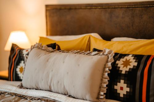 a close up of a bed with pillows on it at The Tribe Alpaca Retreat in Brăneşti