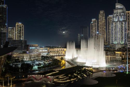 a view of a city at night with a fountain at Best View In Dubai With FULL Burj Khalifa, Fountains, Park View, Next to Dubai Mall and Opera in Dubai
