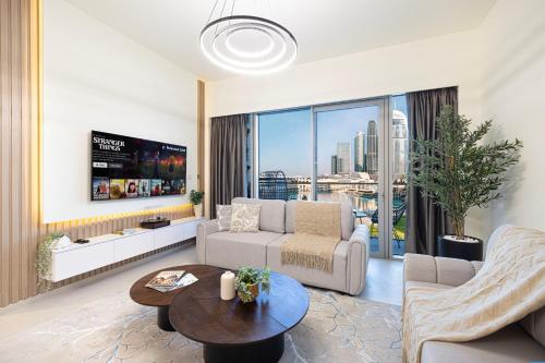 a living room with a couch and a table at Best View In Dubai With FULL Burj Khalifa, Fountains, Park View, Next to Dubai Mall and Opera in Dubai
