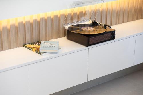 a record player on a counter in a room at Best View In Dubai With FULL Burj Khalifa, Fountains, Park View, Next to Dubai Mall and Opera in Dubai