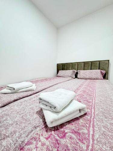 a bedroom with two beds with white towels on them at Apartman Lilly - Zagreb - Mirna Lokacija - Lođa in Zagreb